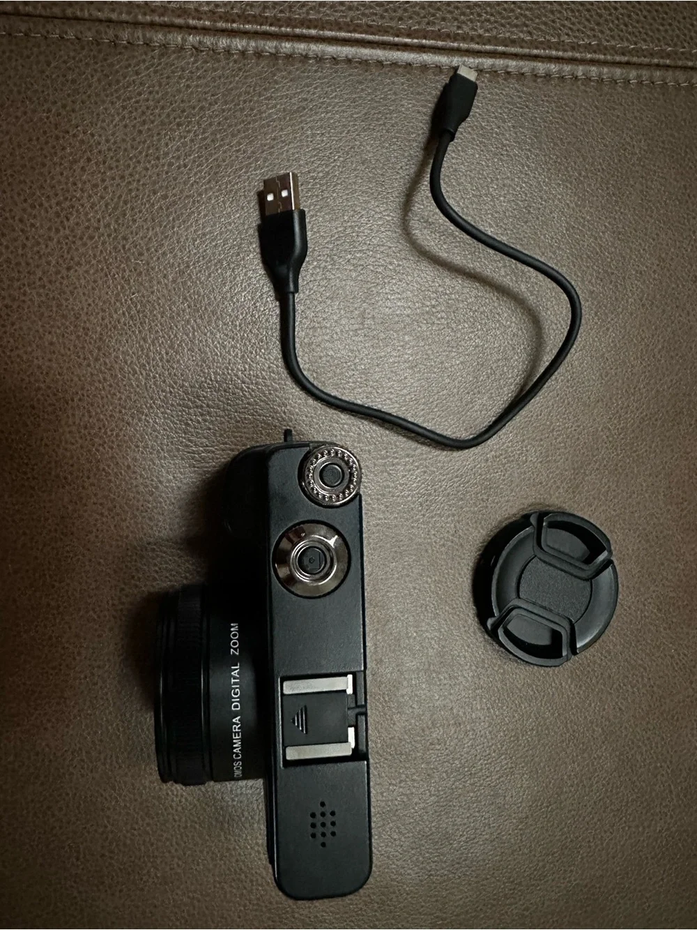 Compact Black Digital Camera with USB Cable and Lens Cap